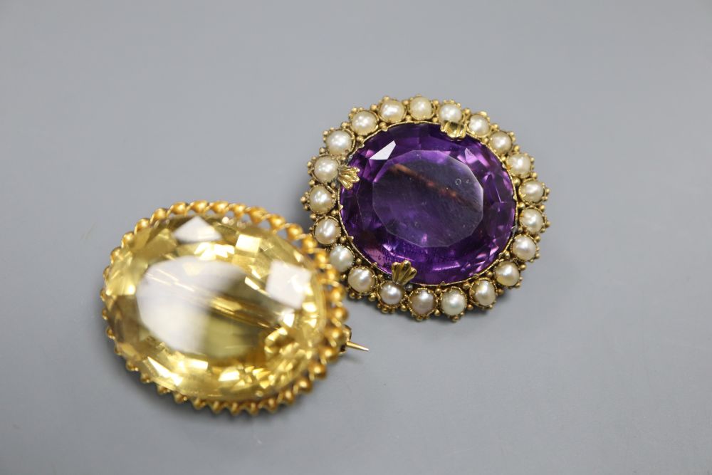 An Edwardian yellow metal, amethyst and split pearl set oval pendant brooch, 30mm and a similar citrine brooch, gross 19.5 grams.